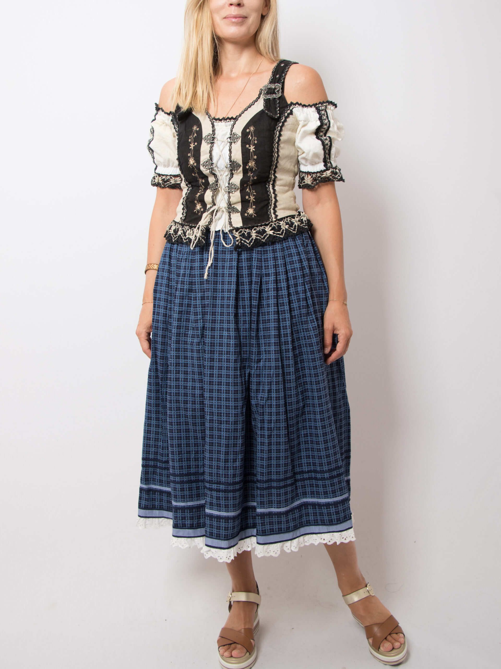 Vintage Folk Blue Plaid Skirt Vintage folk skirt in traditional dirndl style, made from pure cotton, lining acetat. Features a blue base with plaid print. High-waisted, side pockets, and a back zip closure. Classic alpine look in excellent vintage condition. Size XS, see the measures below. m e a s u r e m e n t s (taken while the item is lying flat): waist: 23.5'/ 60 cm length: 33.4'/ 85 cm (Measurements of armpit, waist, and hips are doubled)